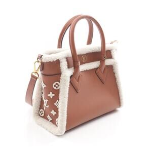 Louis Vuitton On Side My brown shearling handbag white leather